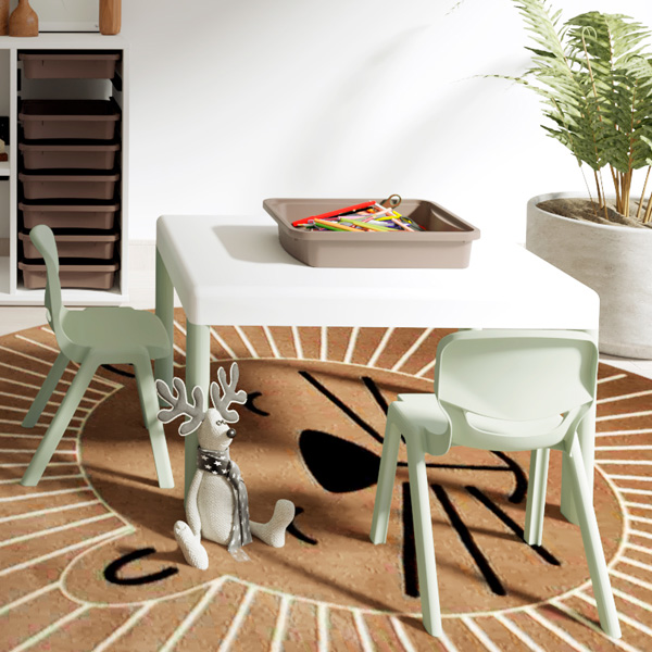Sala de brincar com mesa, cadeiras verdes-claras, materiais de desenho, peluche e tapete redondo.