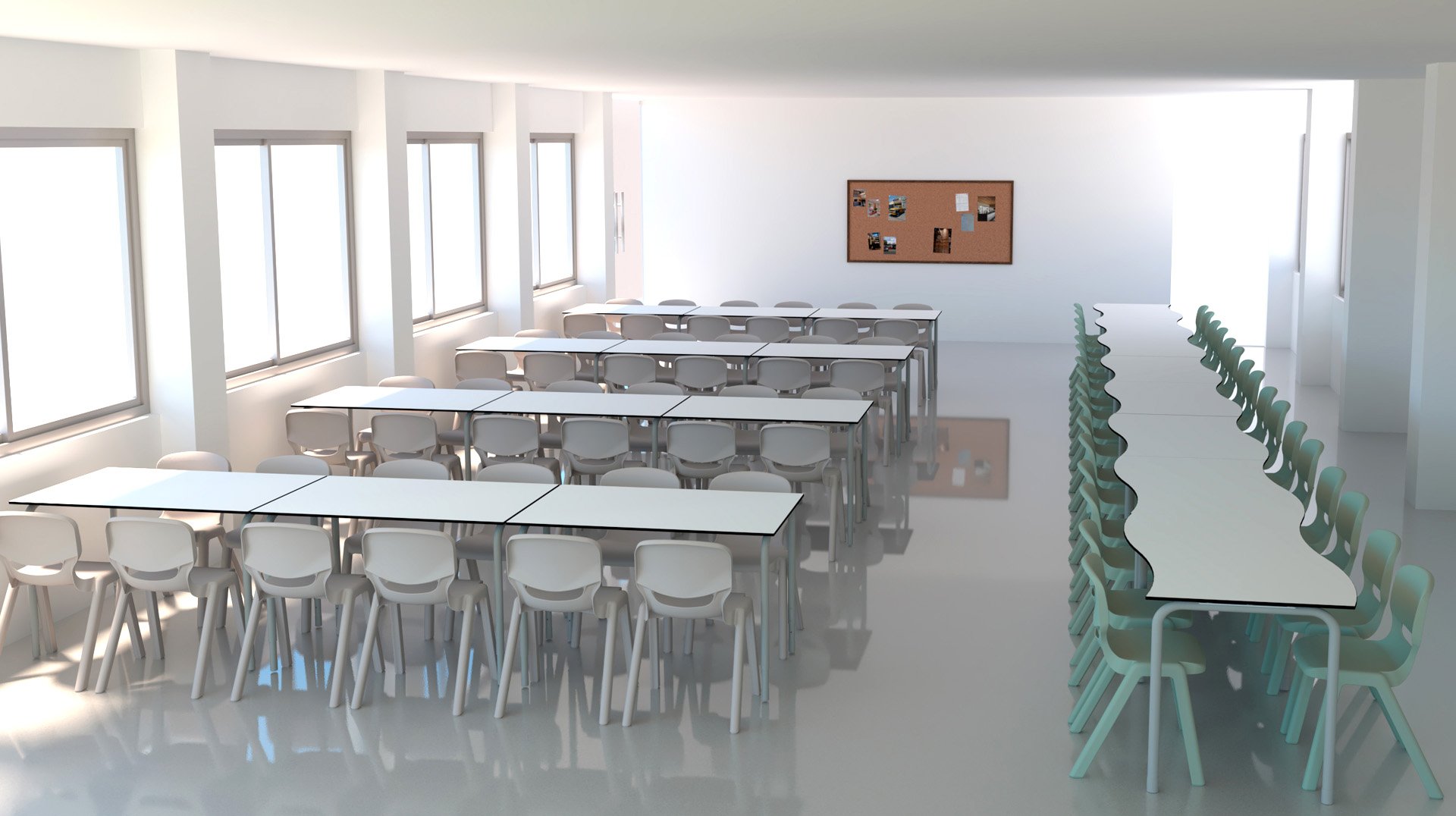 Un aula moderna y luminosa con filas de mesas y sillas blancas, grandes ventanales en un lado y una pizarra de corcho con fotos en la pared del fondo. La sala está vacía y bien iluminada.