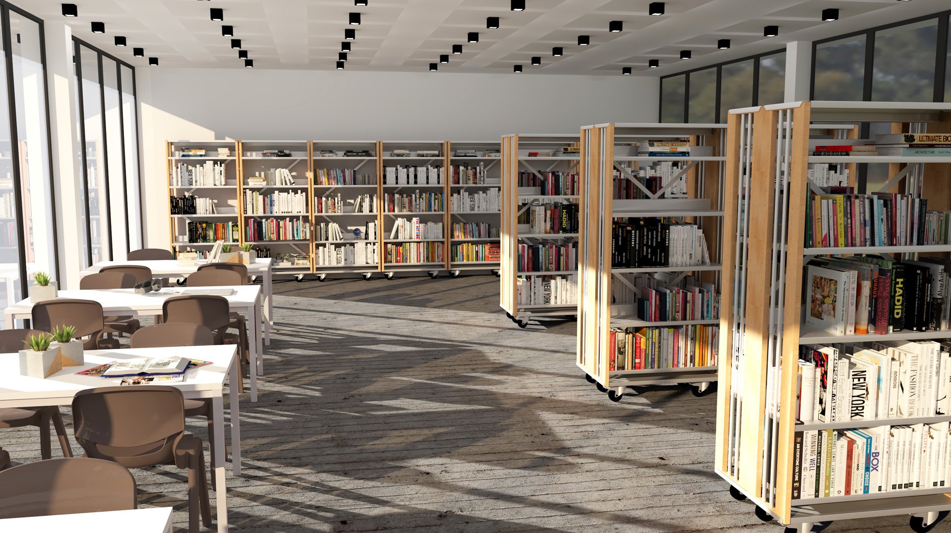 Biblioteca com estantes de livros, mesas e cadeiras junto a grandes janelas.