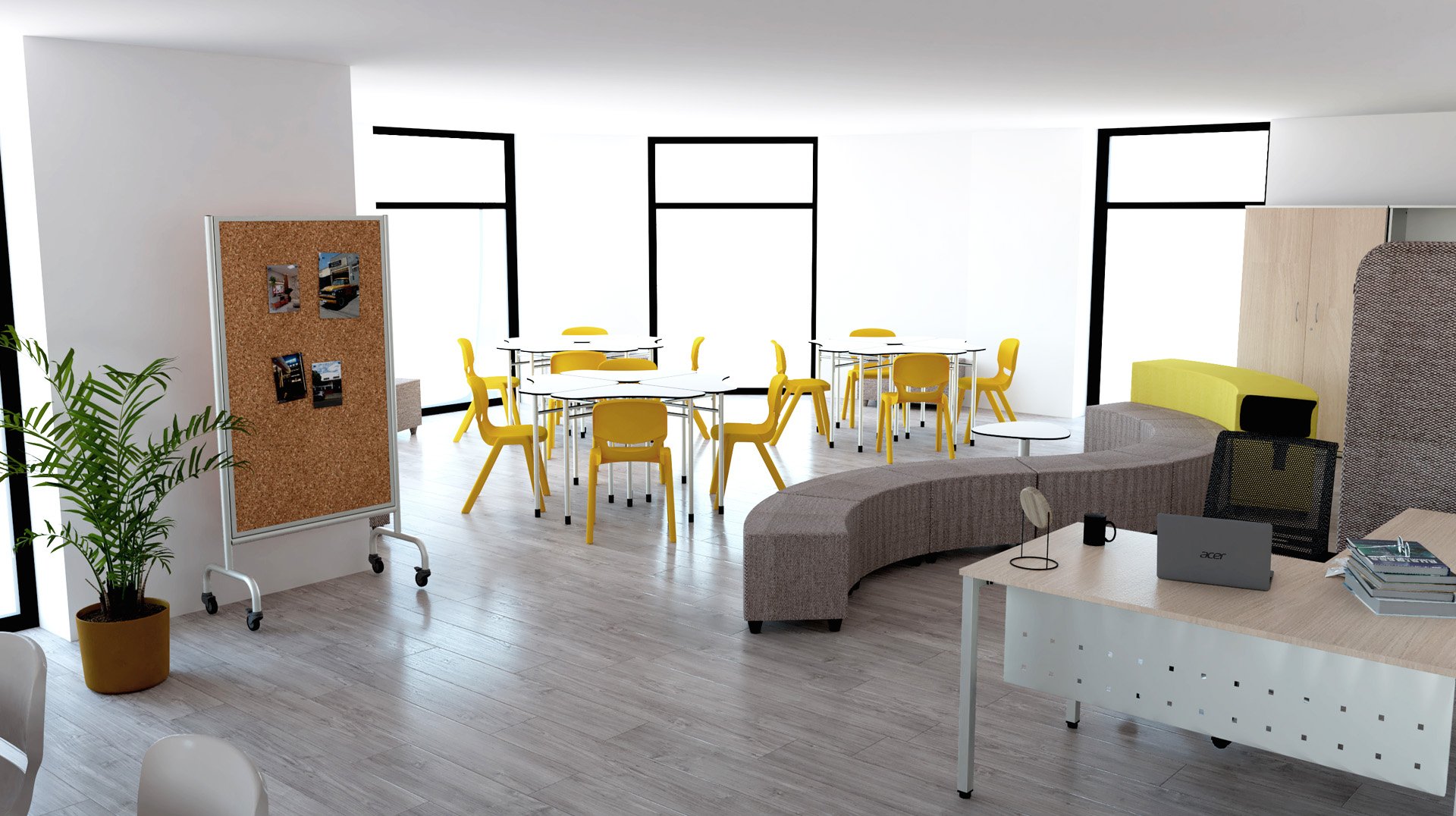 Sala com cadeiras amarelas, mesas redondas, painel de cortiça e zona de assentos curvos cinzentos.