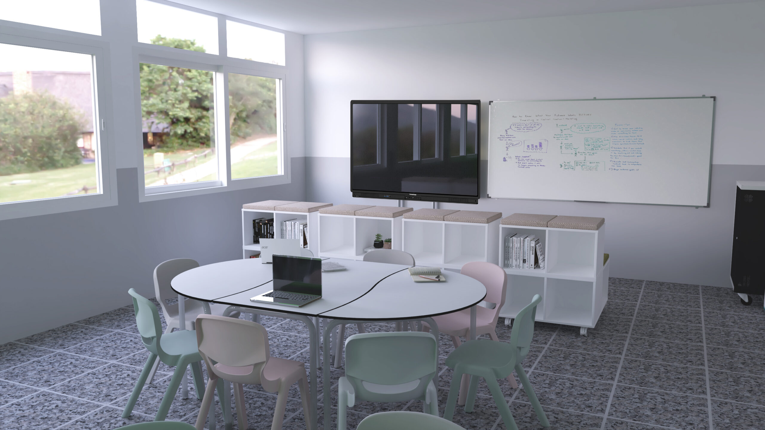 Sala com mesa redonda, cadeiras em tons pastel, computador portátil, estantes e quadro com anotações.