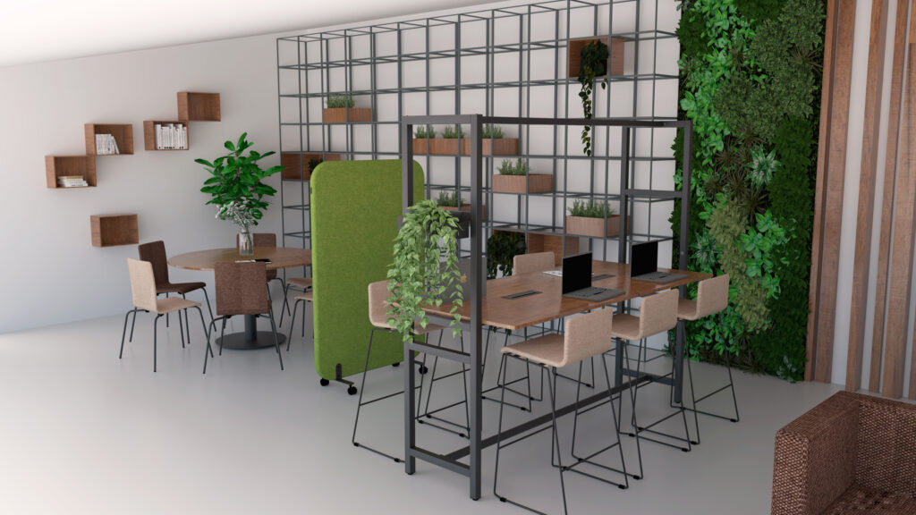 Espaço de trabalho com mesas de madeira, computadores portáteis, estantes e divisórias com plantas.