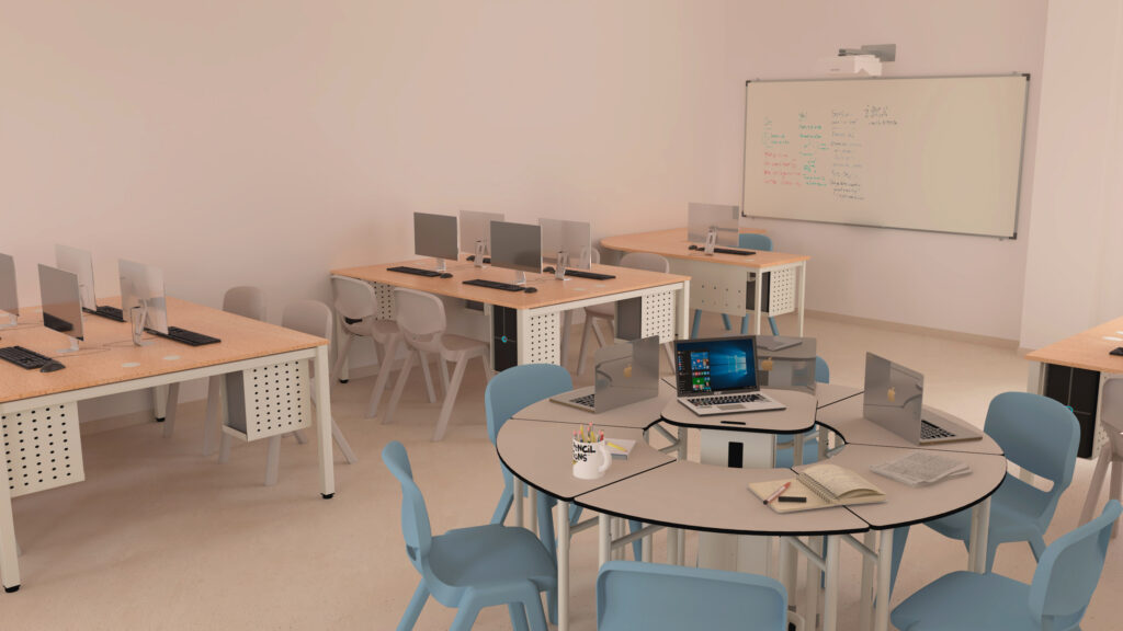 Sala com computadores, cadeiras azuis e mesa redonda com portáteis e cadernos.