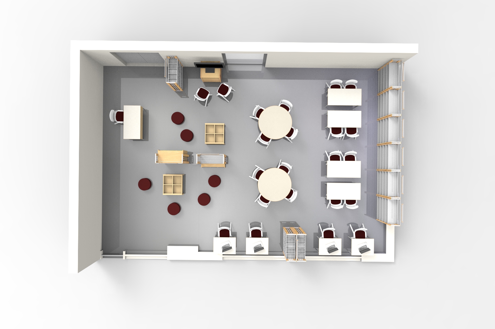 Vista superior de uma sala com mesas redondas e rectangulares, estantes e zonas de trabalho distintas.